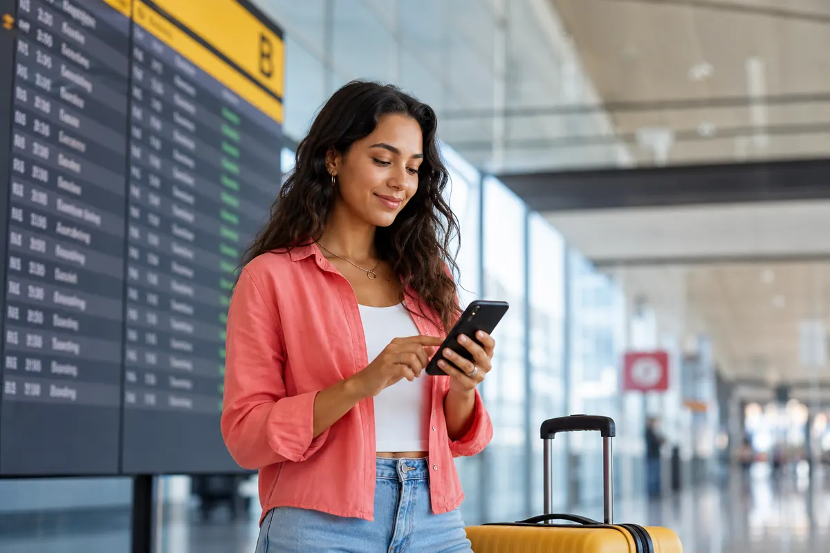 Traveler adjusting network settings and airplane mode on a smartphone.